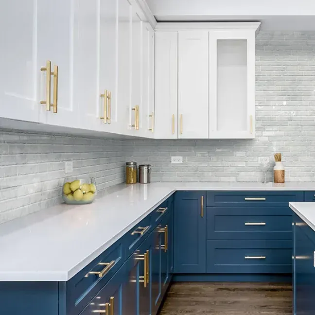 A kitchen with blue cabinets and white counter tops