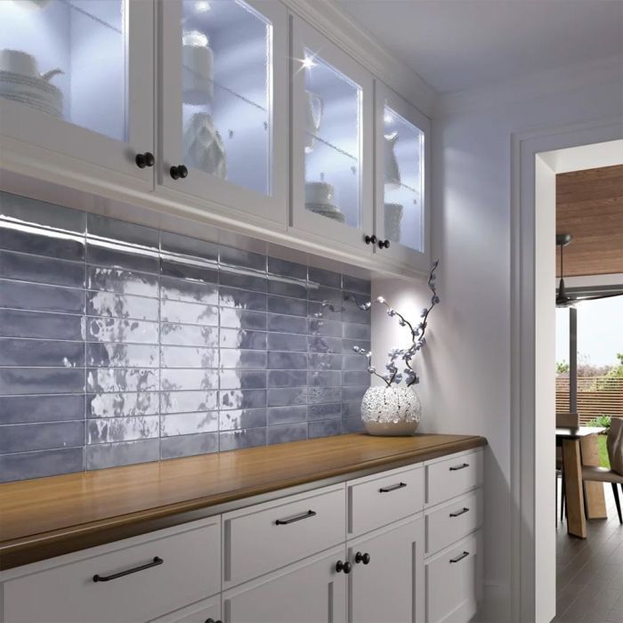 A kitchen with white cabinets and glass doors