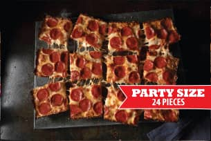 A salad with lettuce , tomatoes , olives and feta cheese on a plate.