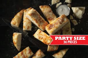 A close up of a plate of food with a sign that says party size 36 pieces.