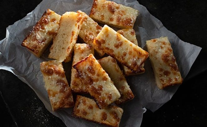 A pile of baked bread on a piece of paper.