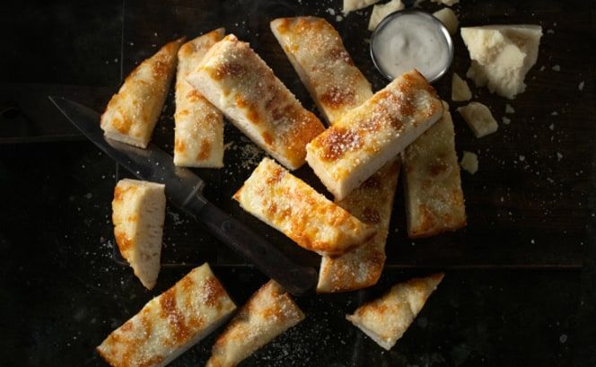 A pile of baked bread on a piece of paper.