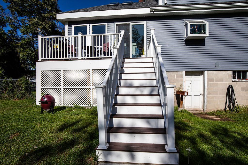 A house with a deck and stairs leading up to it