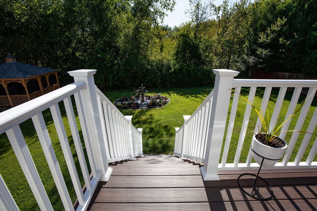 Stairs leading up to a deck with a white railing
