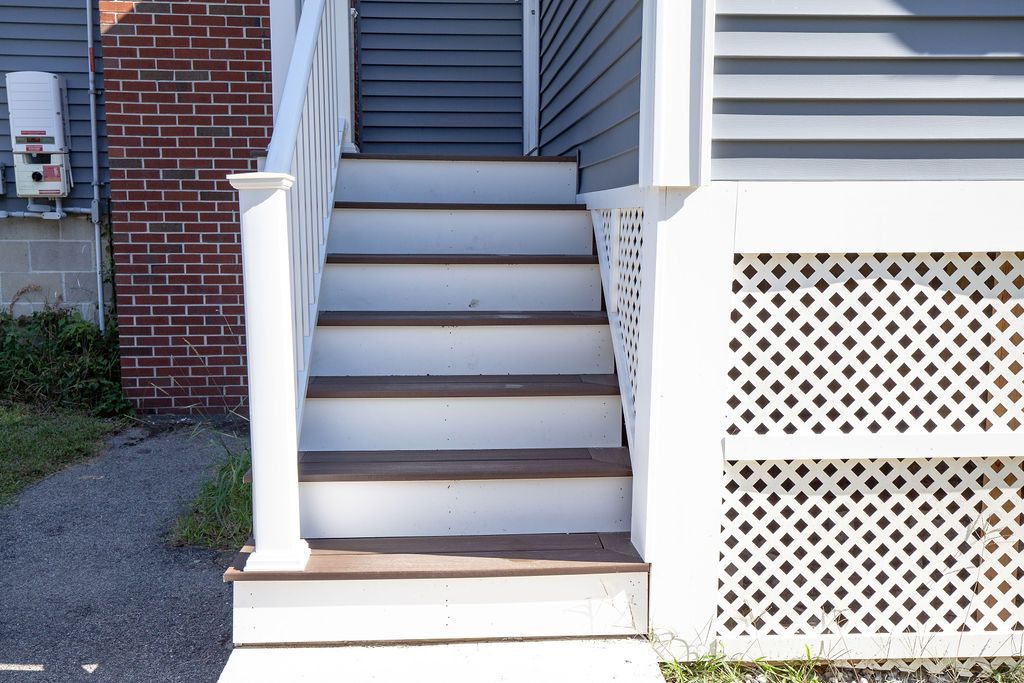 A set of stairs leading up to the front of a house.