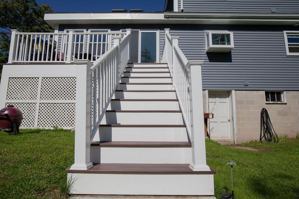 A house with a deck and stairs leading up to it