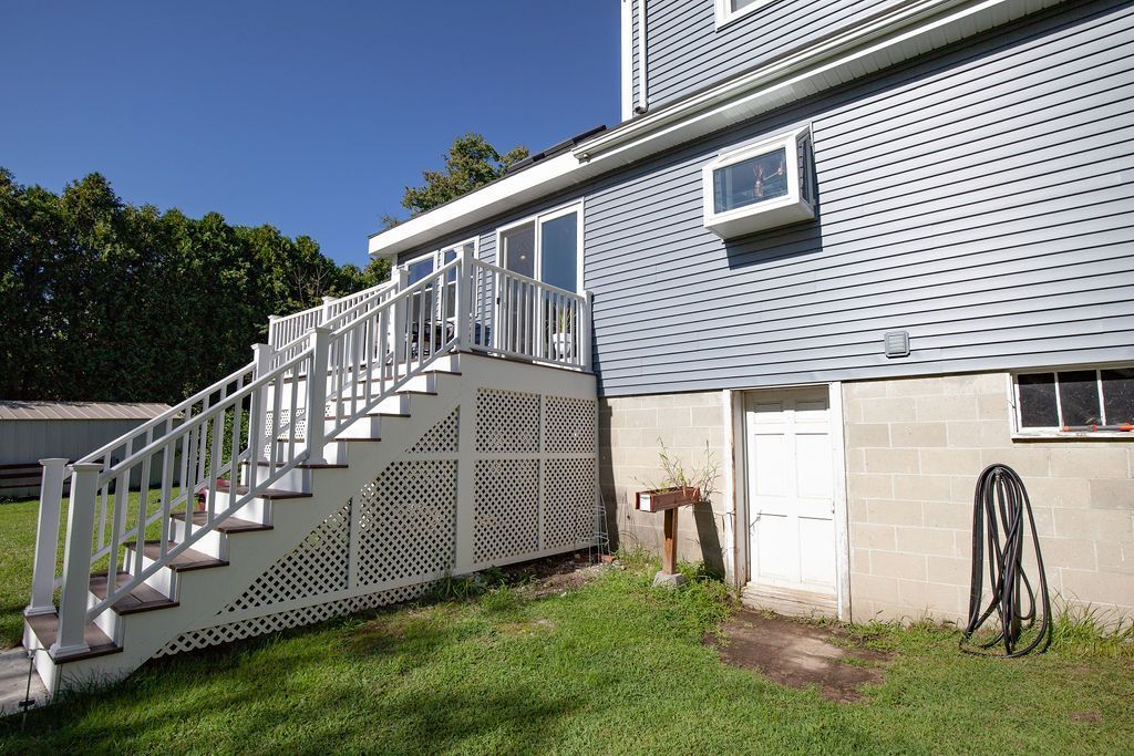 A house with stairs and a hose in front of it