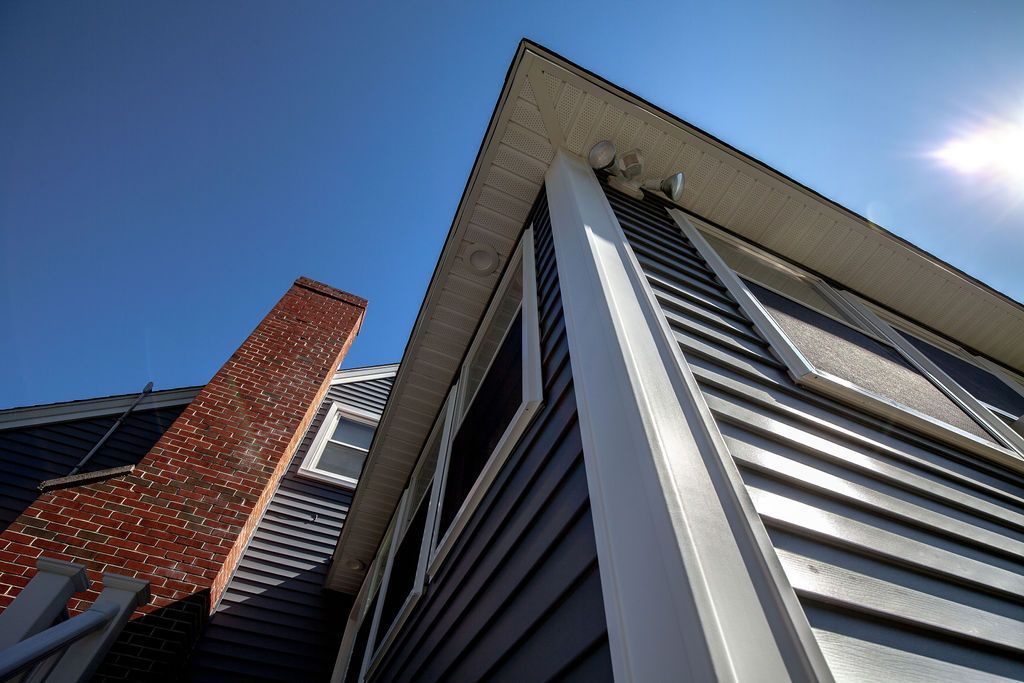 Looking up at the roof of a house with a chimney