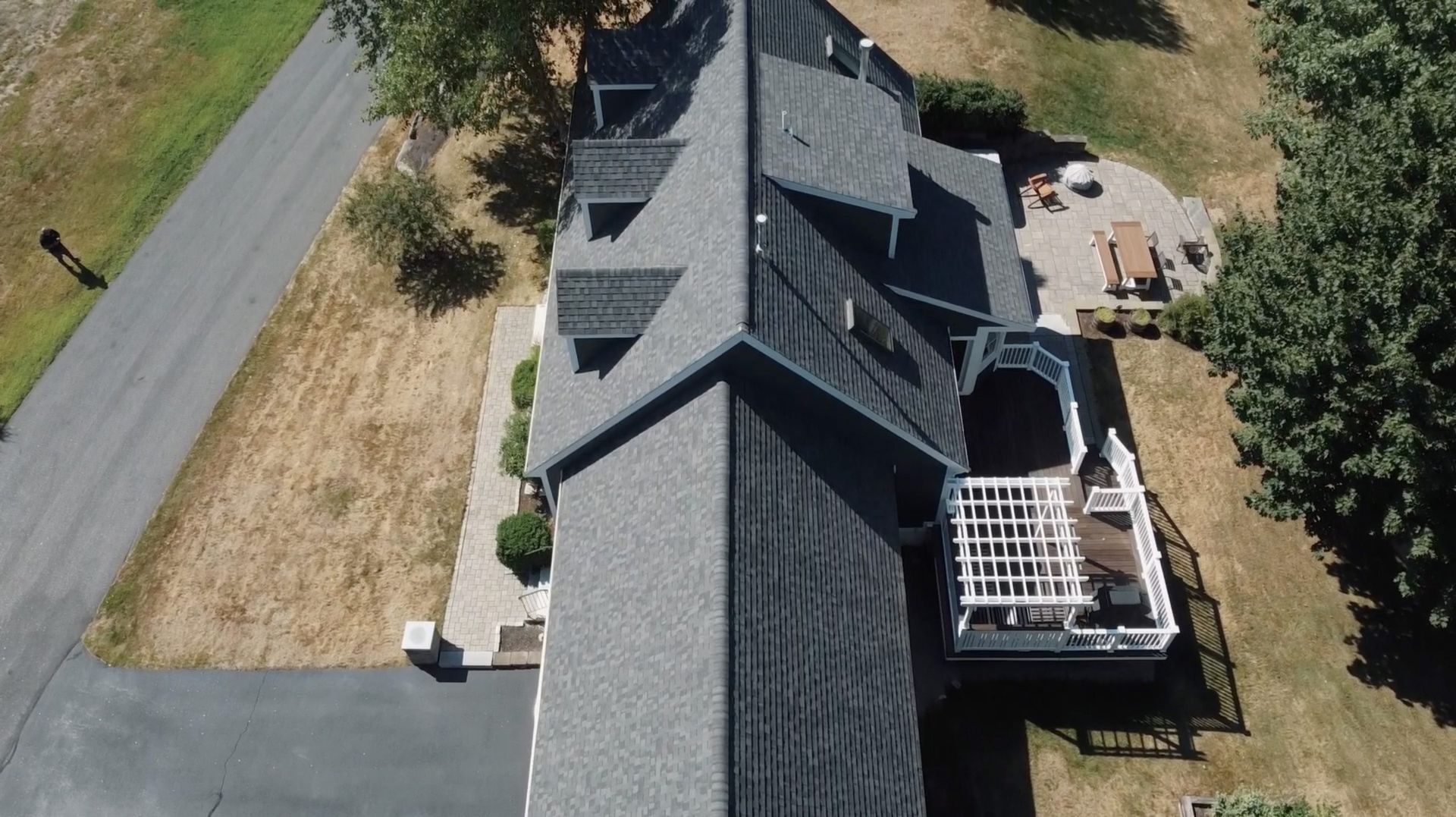 An aerial view of a large house with a gray roof.