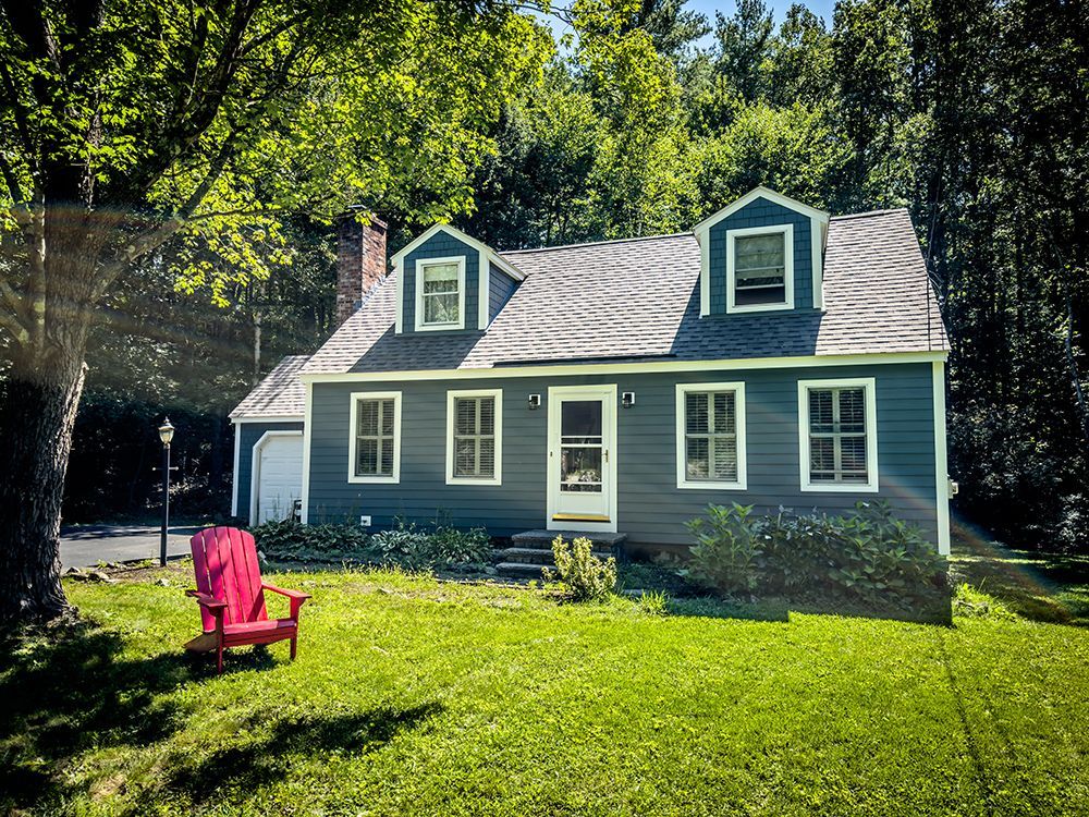 A house with a red chair in front of it