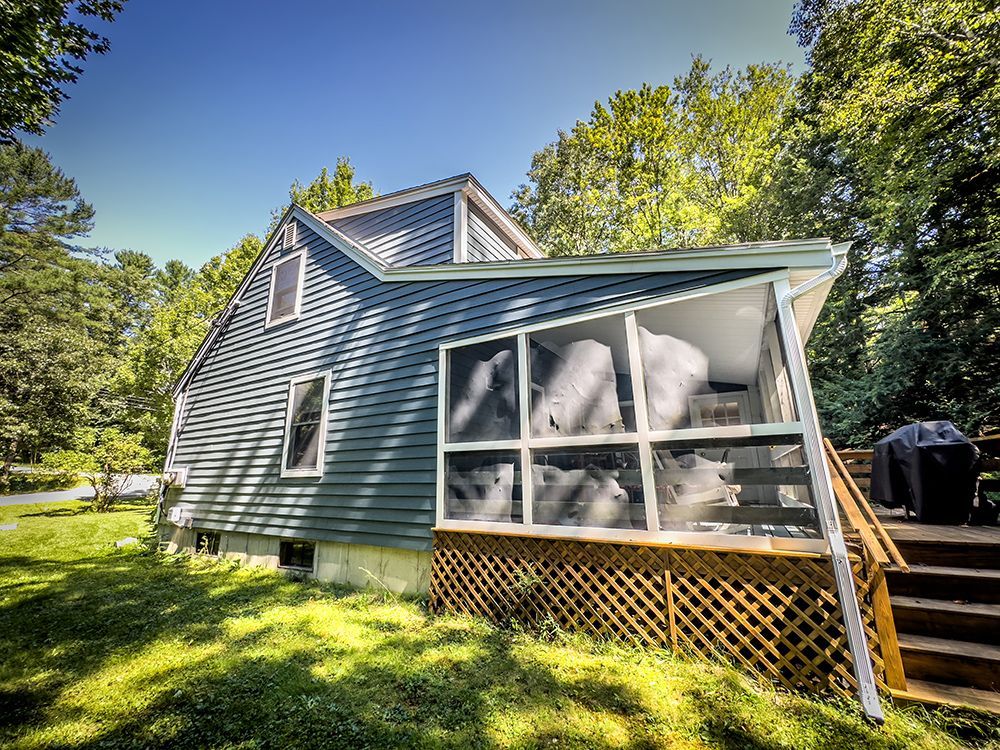 A house with a screened in porch and stairs