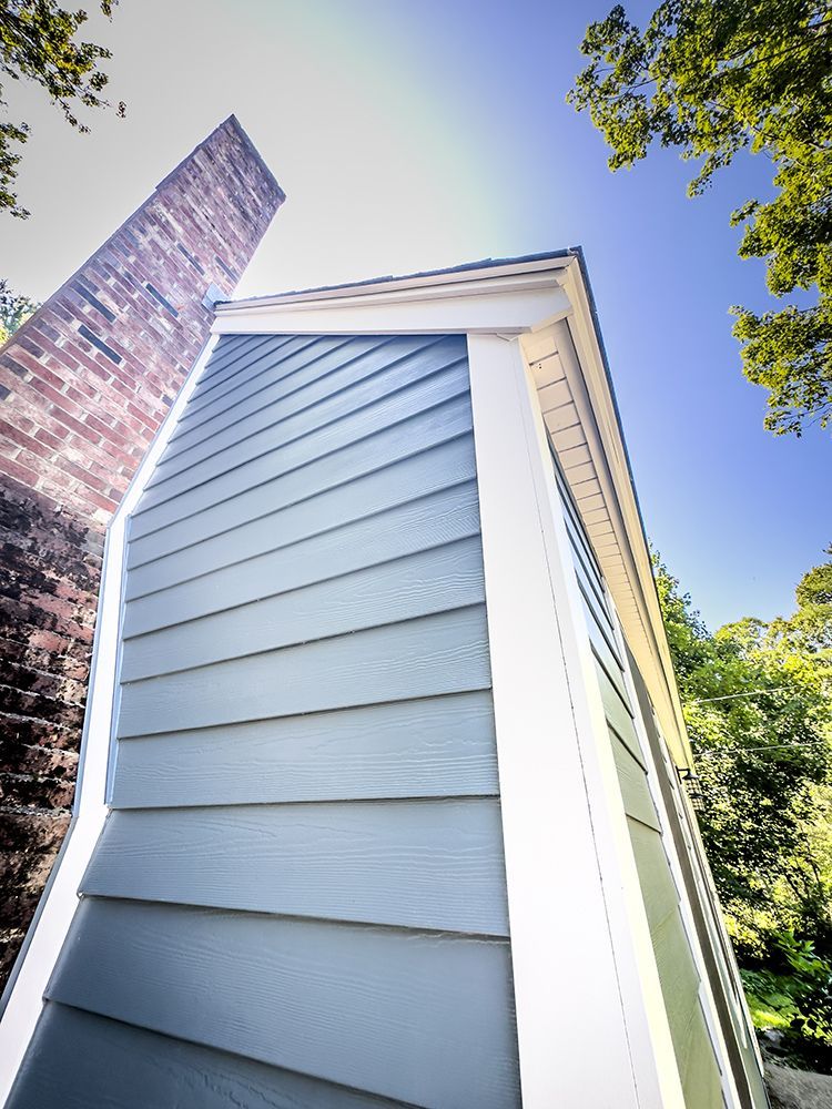 A house with a chimney on the side of it.