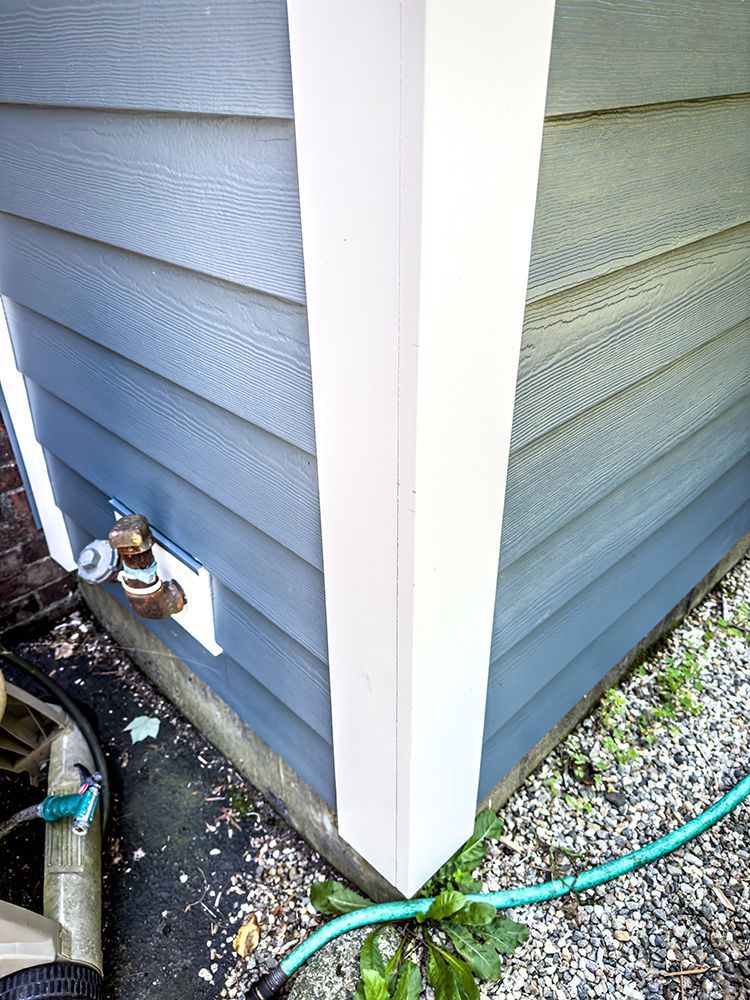 A hose is attached to the side of a house.