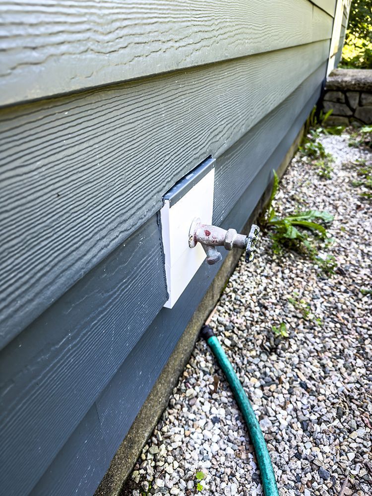 A hose is attached to the side of a house.