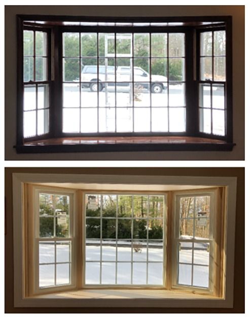 Two bay windows: dark wood with black muntins above, light wood with white muntins below.