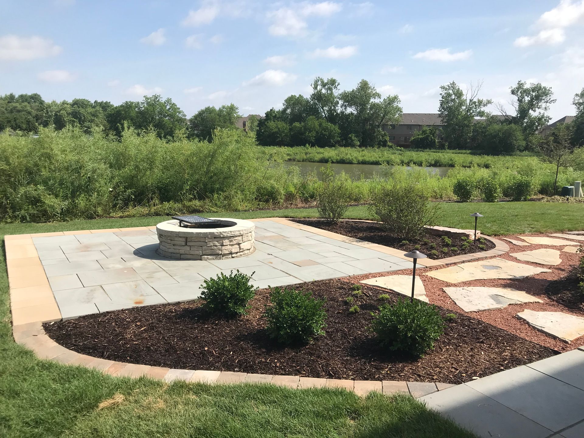 There is a fire pit in the middle of the patio.