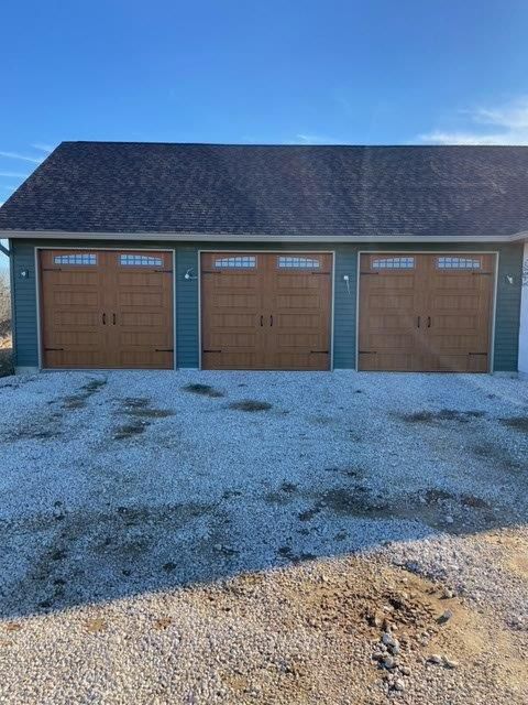 A residential garage with three garage doors