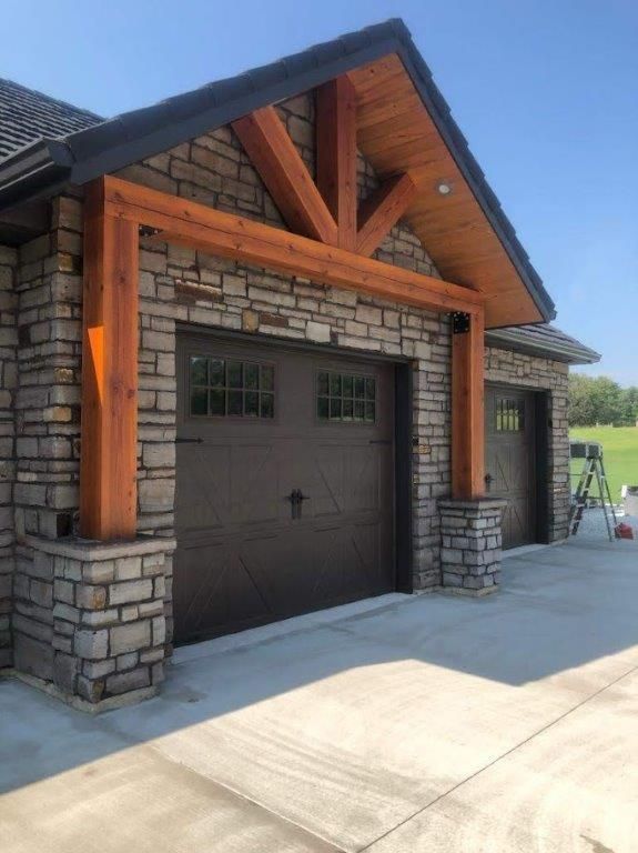 A brick building with two garage doors