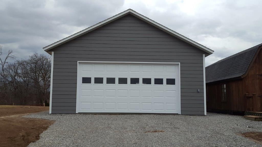 A gray garage with a white garage door