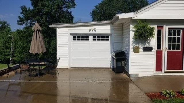 A white house with a white garage door