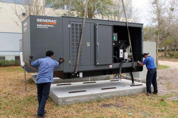 Two men are working on a generator outside of a building.