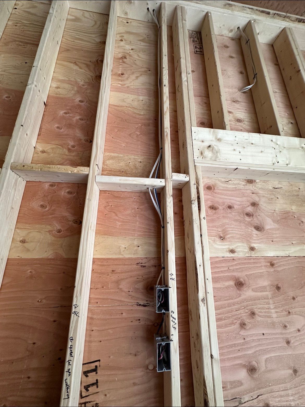 A wooden wall with a wire coming out of it.