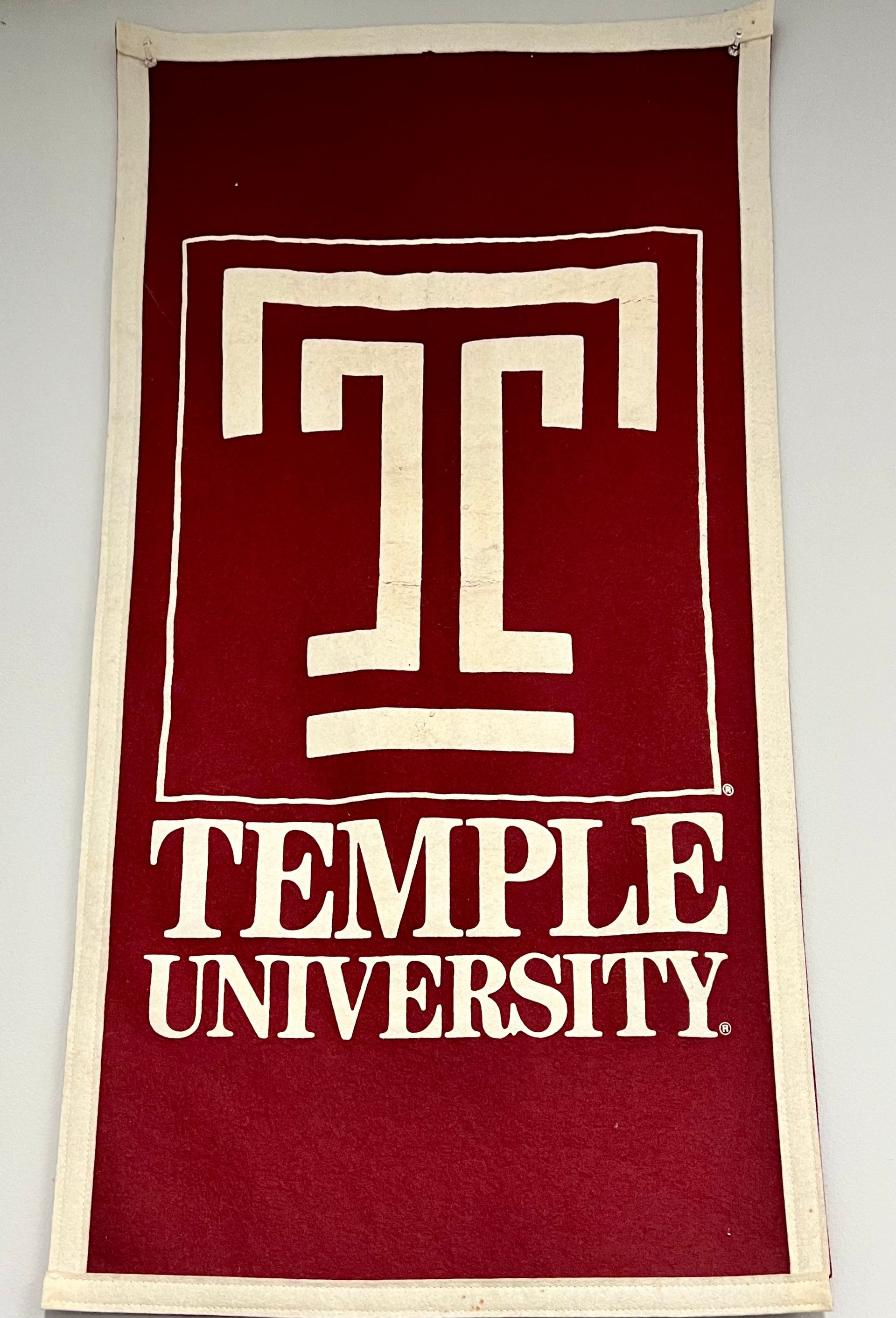 A red banner with the temple university logo on it