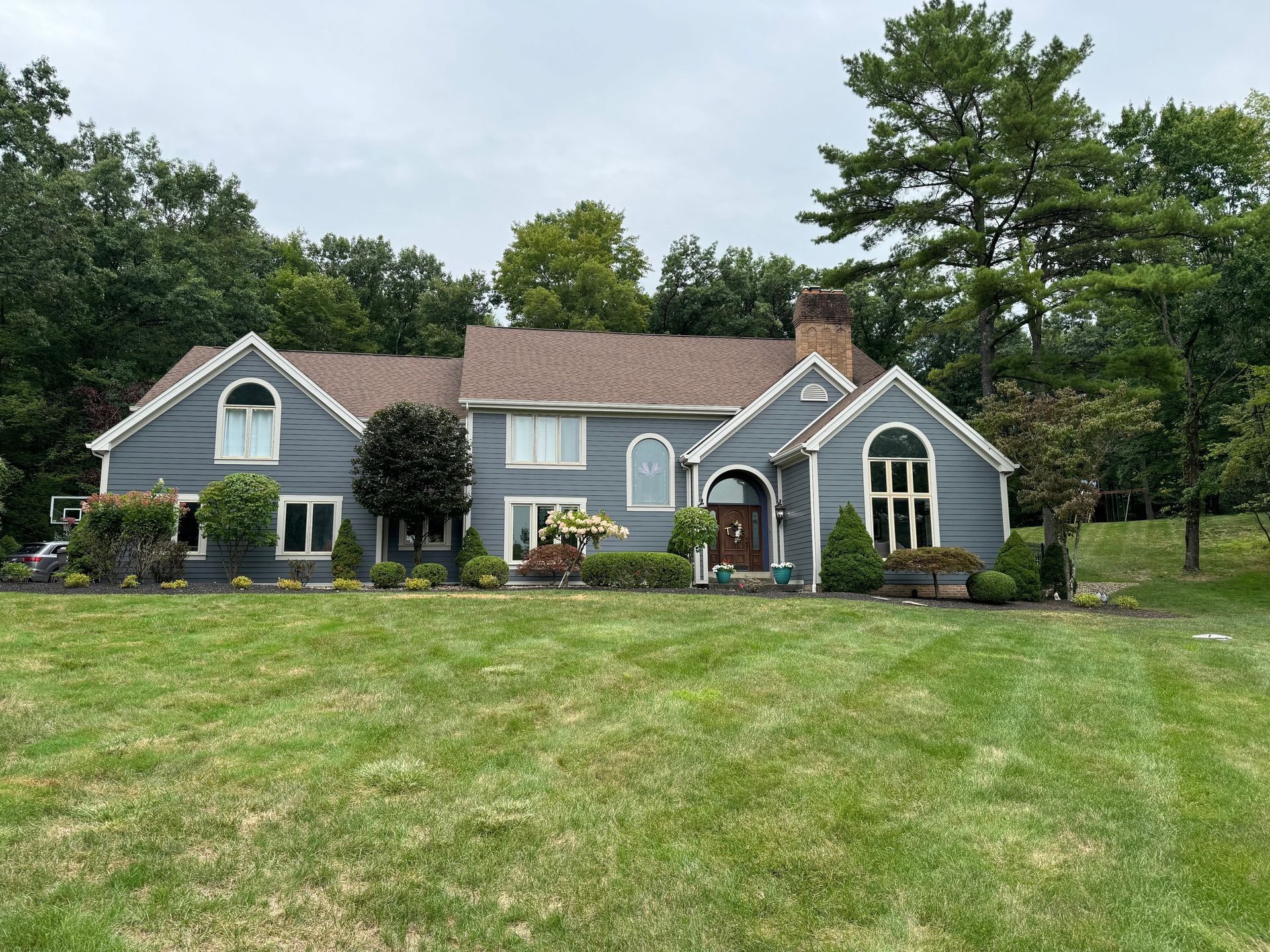 A large house with a large lawn in front of it.