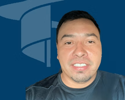 Silhouette of a person in a suit, head and shoulders, against a gray background.