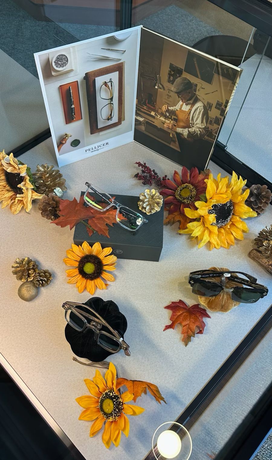 Assorted floral hair clips and accessories displayed on a table with sunflowers and autumn leaves.