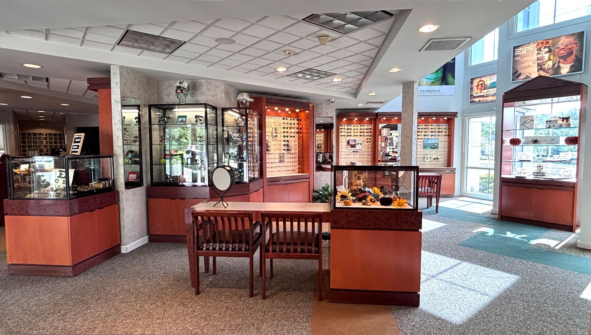 Museum exhibit gallery with display cases, posters, and a bench in a bright room