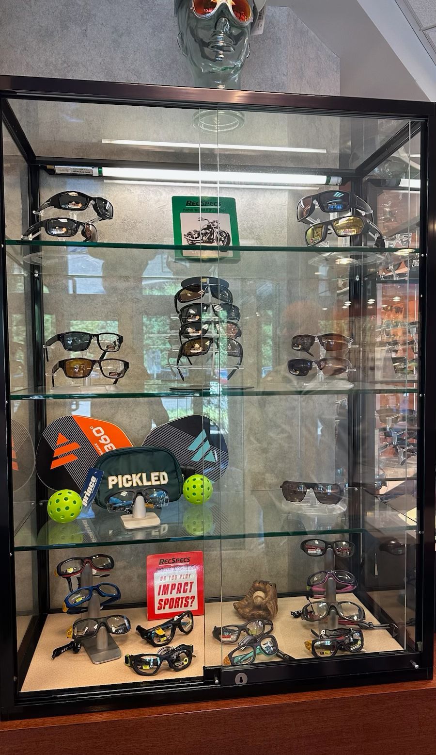 Glass display cabinet filled with vintage toy robots and robot-themed collectibles