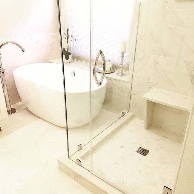 A bathroom with a tub and a walk in shower