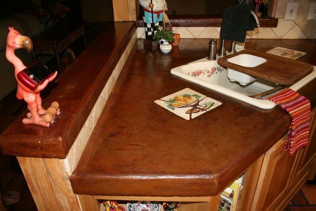 A kitchen counter with a sink and a flamingo statue