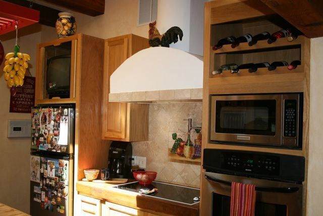 A kitchen with a stove top oven and a microwave