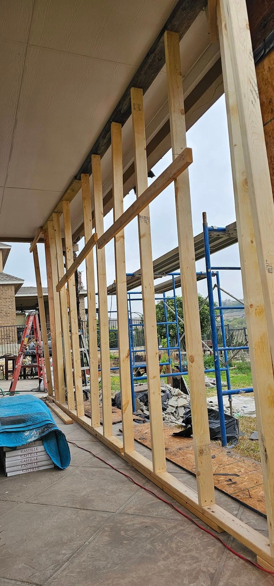 A building is being built with wooden beams and scaffolding.