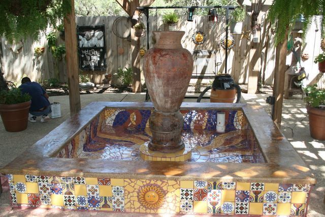 A fountain with a large vase in the middle of it