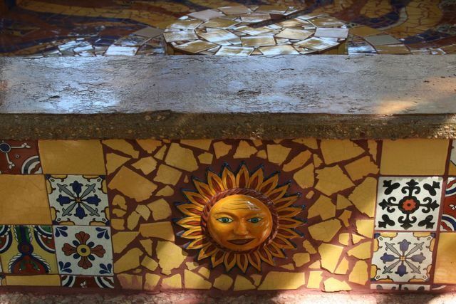 A mosaic of a sun with a face on it