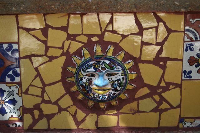 A painting of a sun with a face on it