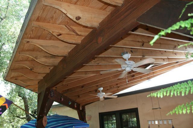 A ceiling fan is hanging from the roof of a house