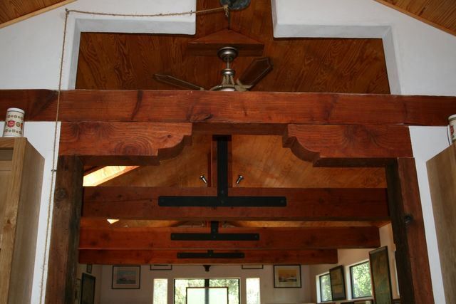 A room with wooden beams and a ceiling fan
