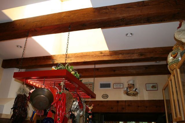 A kitchen with pots and pans hanging from the ceiling
