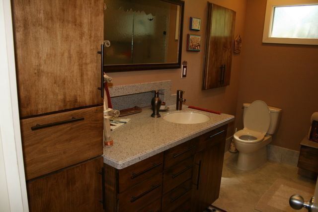 A bathroom with a sink , toilet and mirror.