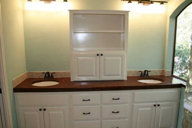 A bathroom with two sinks and a window