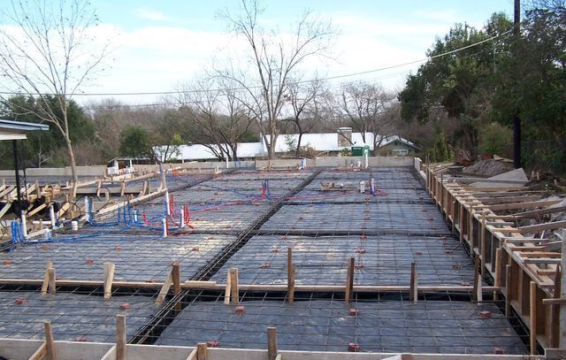 A concrete floor is being built in a construction site.