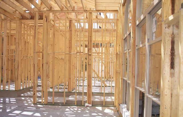 A house is being built with wooden beams and windows