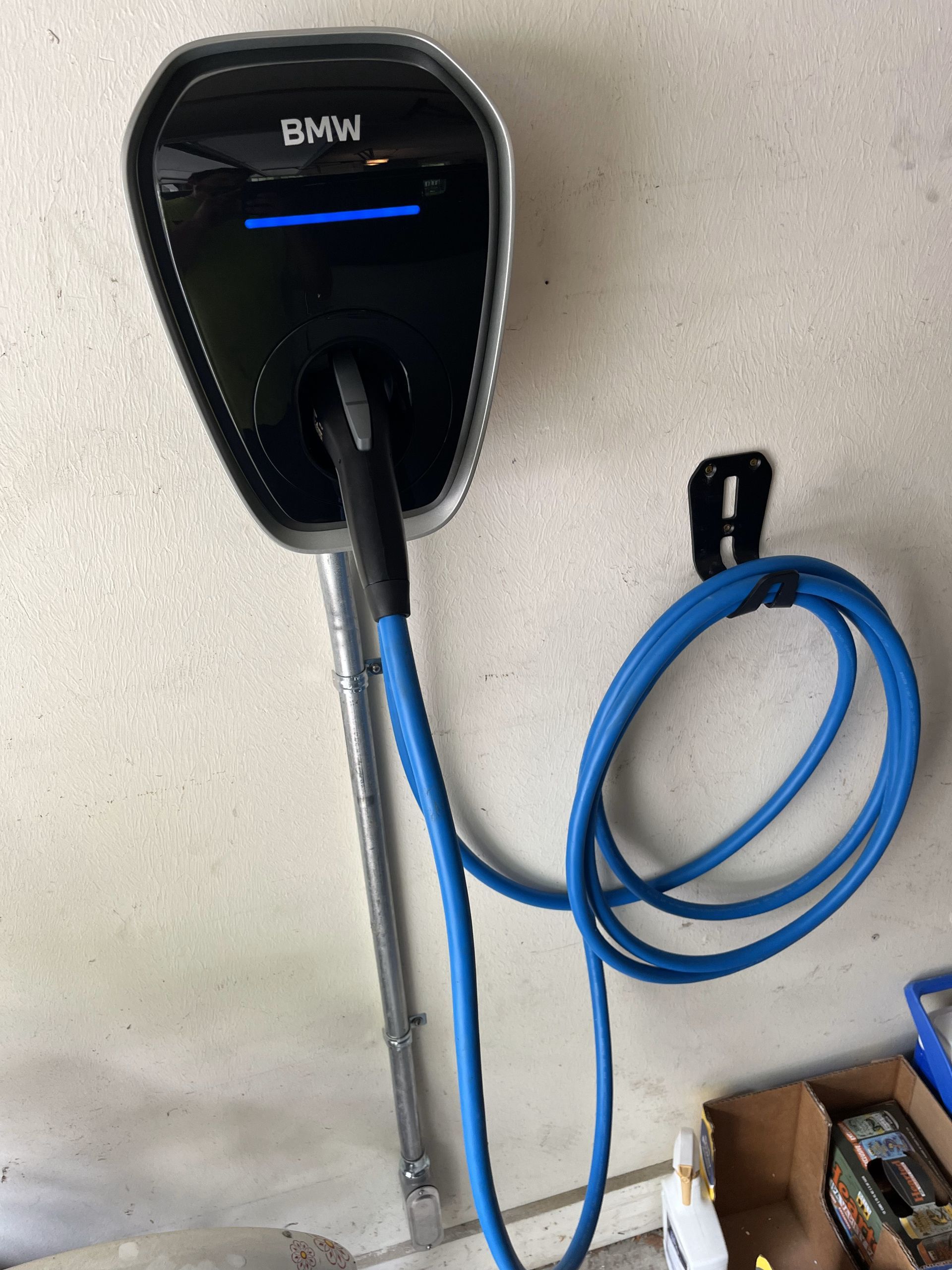 A bmw charging station with a blue cable attached to it