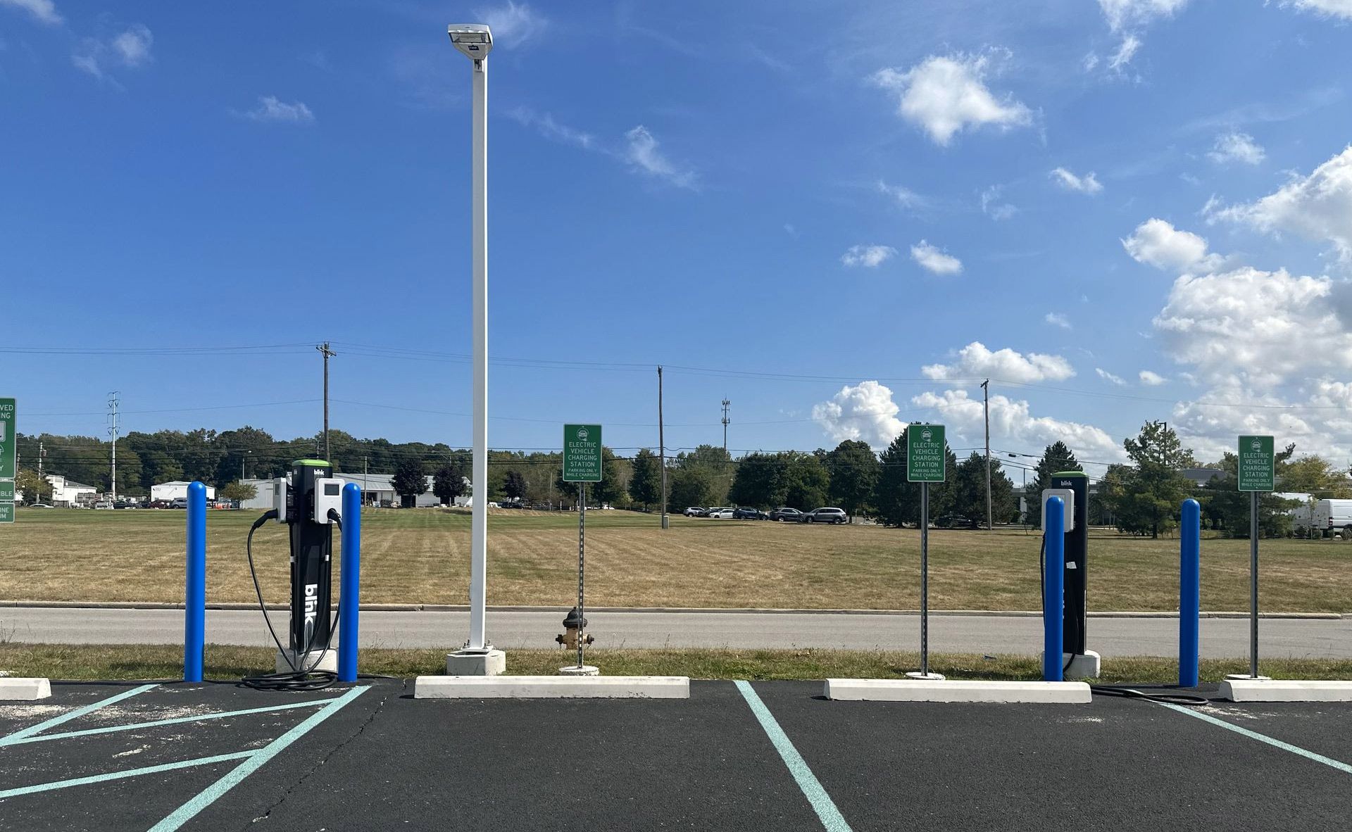 A parking lot with a lot of charging stations in it.