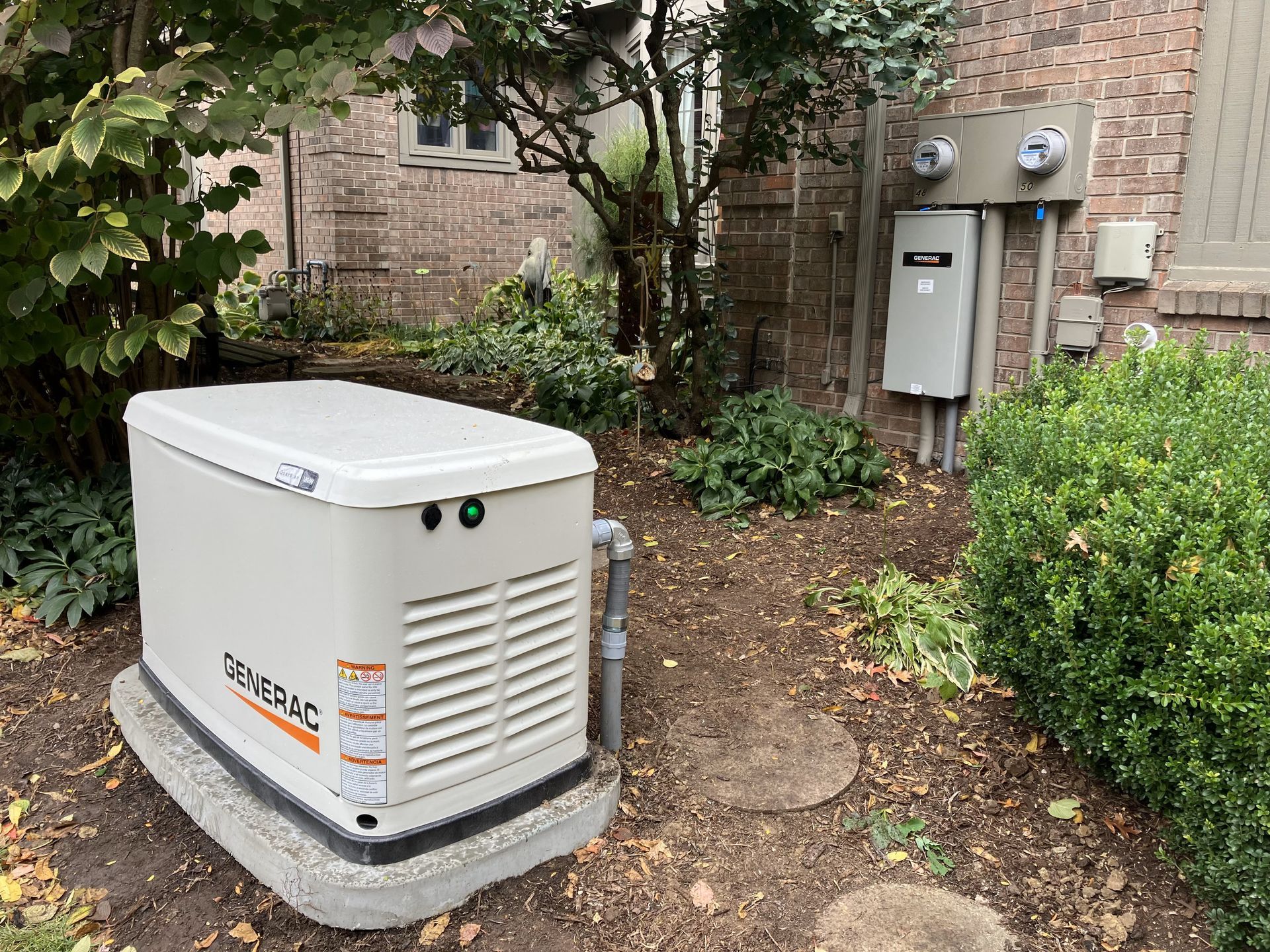 A generator is sitting in the backyard of a house.