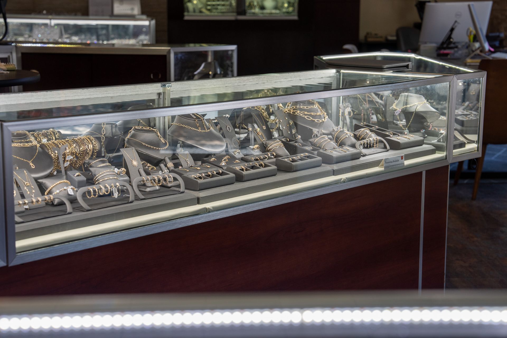 Glass display case filled with assorted jewelry in a store